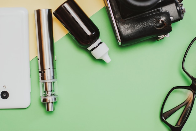 Vaping set and coffee on the colorful background