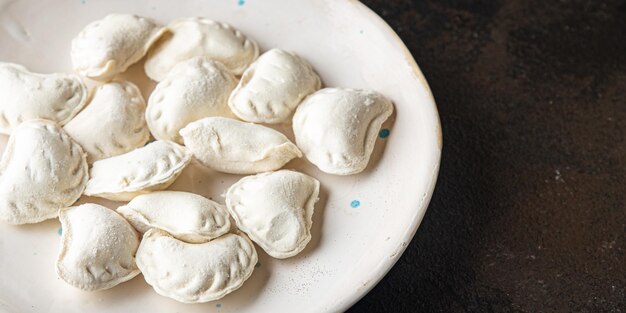 vareniki raw frozen stuffed dumplings semifinished meal snack on the table copy space