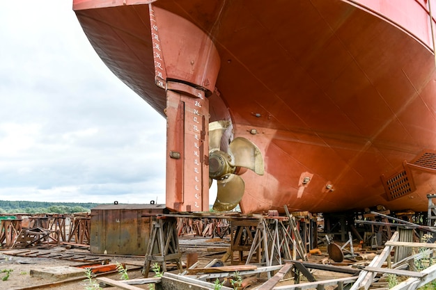 Variable pitch propeller and rudder cargo vessel ashore on ship\
repairing yard