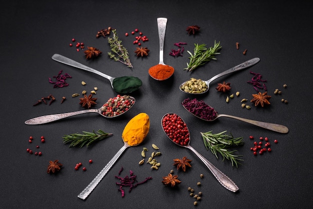 Premium Photo | Variation of spices in metal spoons paprika turmeric ...
