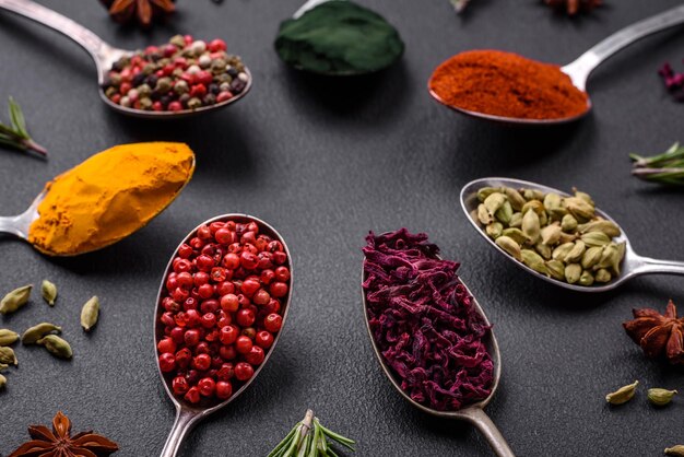 Premium Photo | Variation of spices in metal spoons paprika turmeric ...