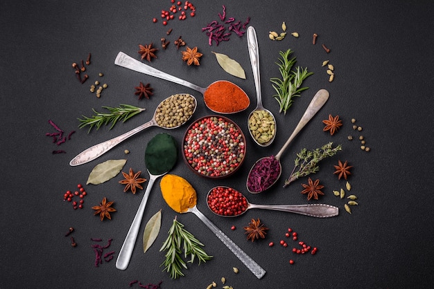 Premium Photo | Variation of spices in metal spoons paprika turmeric ...