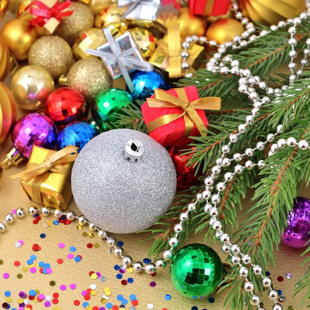 Varicolored Christmas decorations on a spruce branch