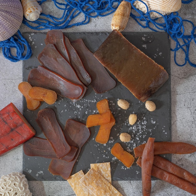 varied salting of fish roe and tuna mojama on black slate plate