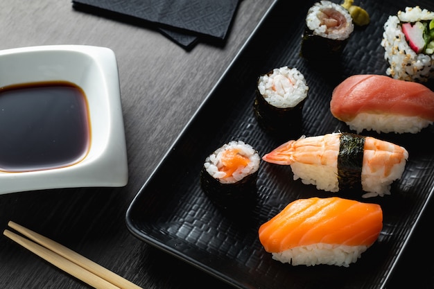 Varied sushi plate on wood table