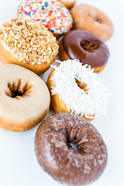 Variery of fresh donuts on a white background.