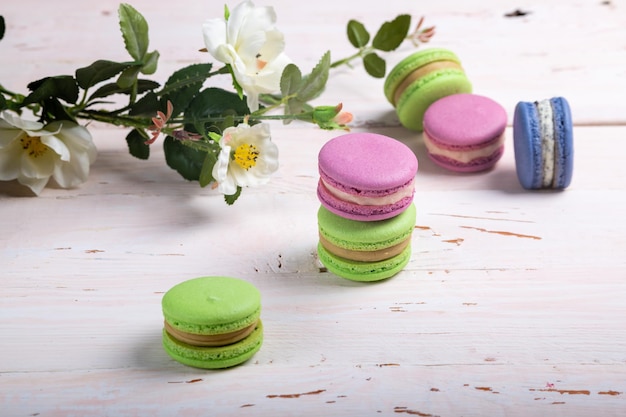 A variety of almond French macaroon biscuits on a light wooden table