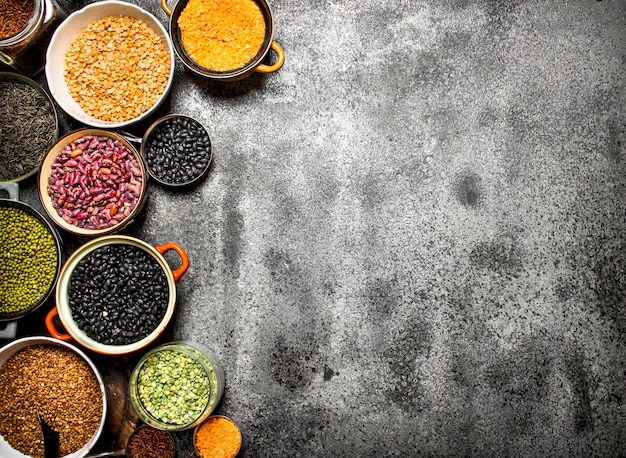 Variety of bean seeds in a bowl. On rustic background.