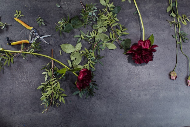 A variety of beautiful flowers lying on a grey table.