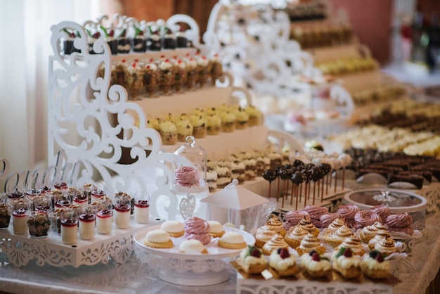 Variety of candies, cakes and cupcakes at the candy bar