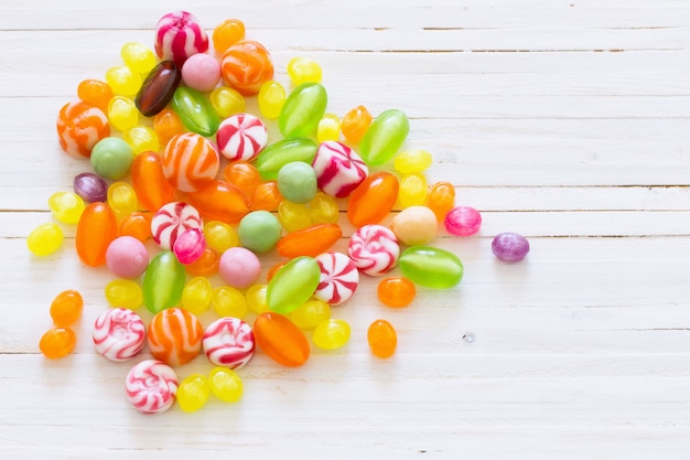 Variety of candies on a wooden table