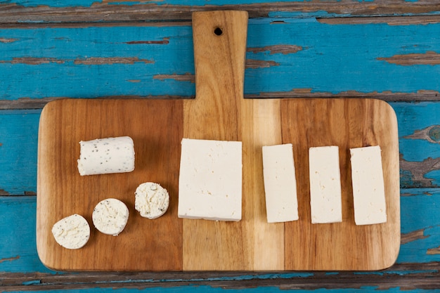 Variety of cheese arranged on chopping board