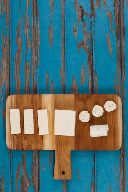 Variety of cheese arranged on chopping board