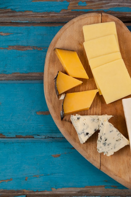 Variety of cheese on heart shaped chopping board