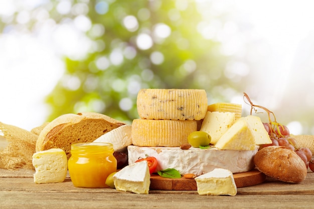 Variety of cheese types composition on wooden board