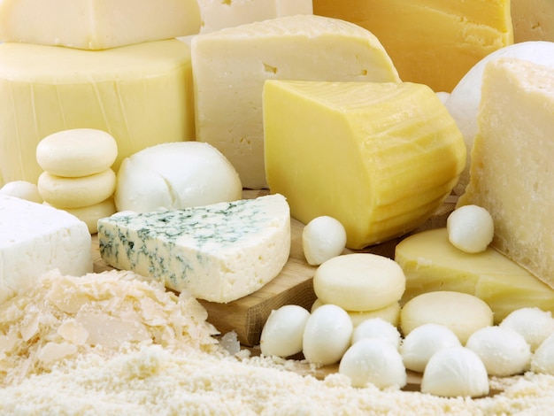 A variety of cheeses are on a table.