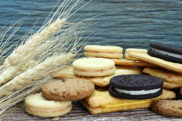 木製のテーブルにさまざまなチョコレート クッキー 大麦植物で撮影したチョコレート チップ クッキー