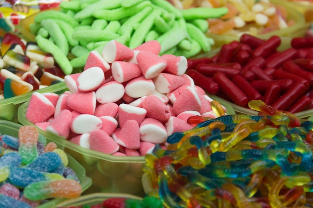 Variety of colorful candies Pink gummies sour jellybeans gumdrop gummy candy unhealthy food