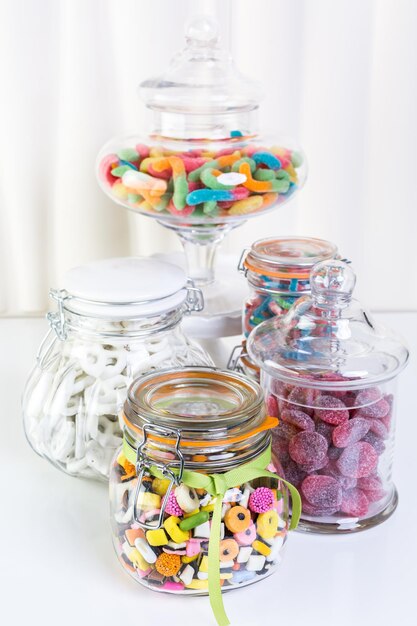 Variety of colorful candies on a white background.