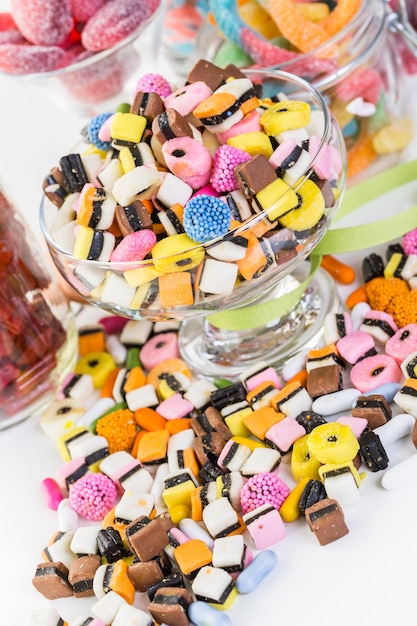 Variety of colorful candies on a white background.