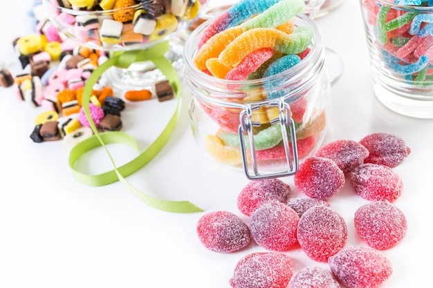 Variety of colorful candies on a white background.