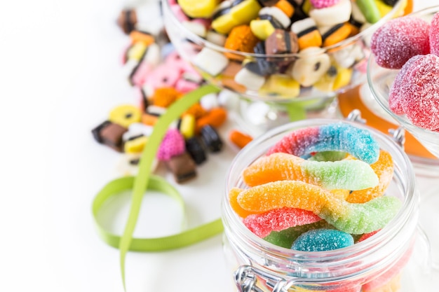 Variety of colorful candies on a white background.