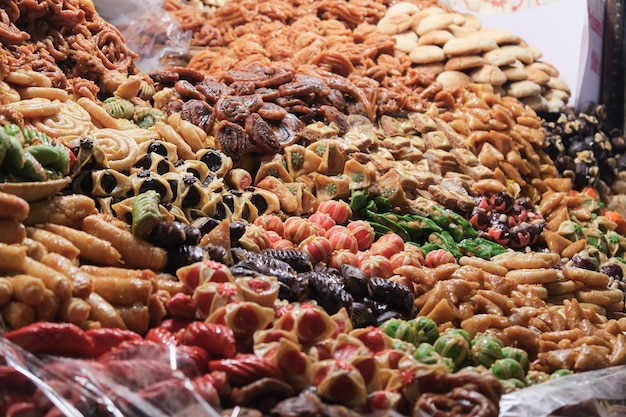 Variety of colorful desserts at Moroccan souk market. Marrakech, Morocco.