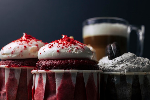 Variety of cupcakes with a cup of coffee over wood tablet