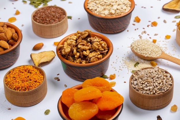 A variety of dried fruits and nuts are on a table.