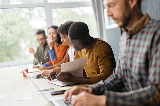 Variety of employees sitting at a desk in a coworking center