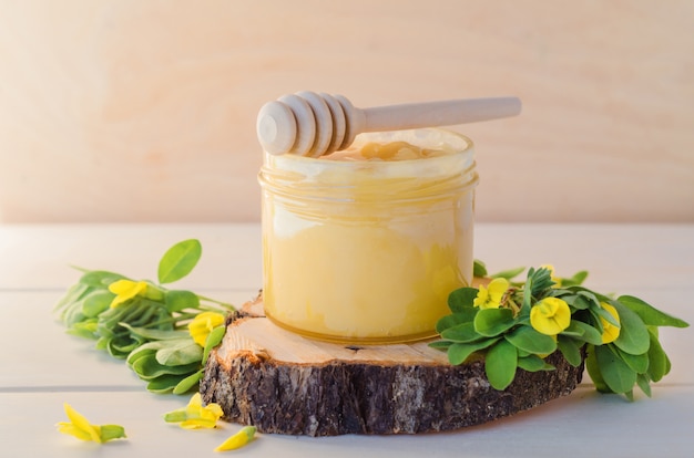 Variety flower honey from yellow acacia on wooden background