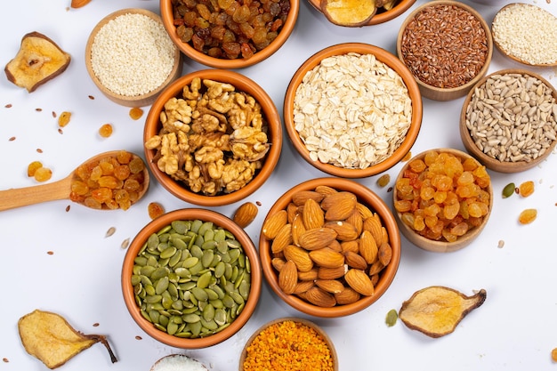 A variety of foods including nuts, seeds, and seeds are on a table.