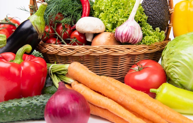 Variety of fresh organic ripe vitamin vegetables and leafy greens in basket close view