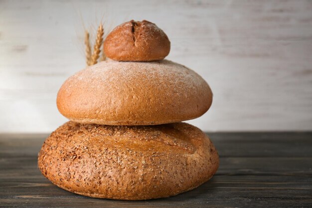 Variety of fresh tasty bread on wooden table