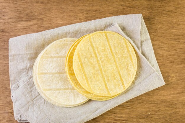 Variety of fresh tortillas on a wood background.