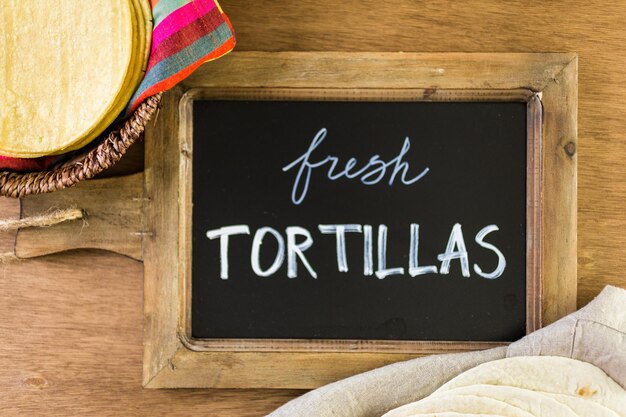 Variety of fresh tortillas on a wood background.