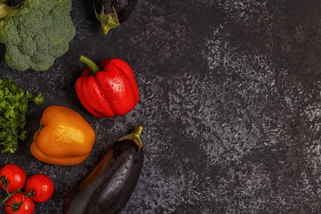 Variety of fresh vegetables on the dark table