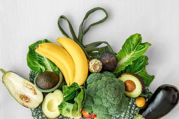 A variety of fresh vegetables and fruits on a white background flat lay