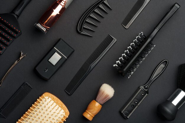 Photo variety of hair styling tools and accessories displayed on a dark background