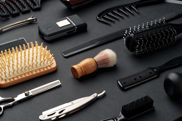 Variety of hair styling tools and accessories displayed on a dark background