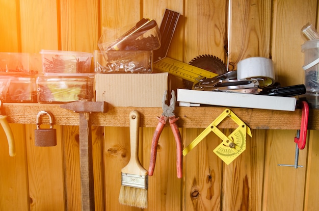 Variety handy tools on wood wall