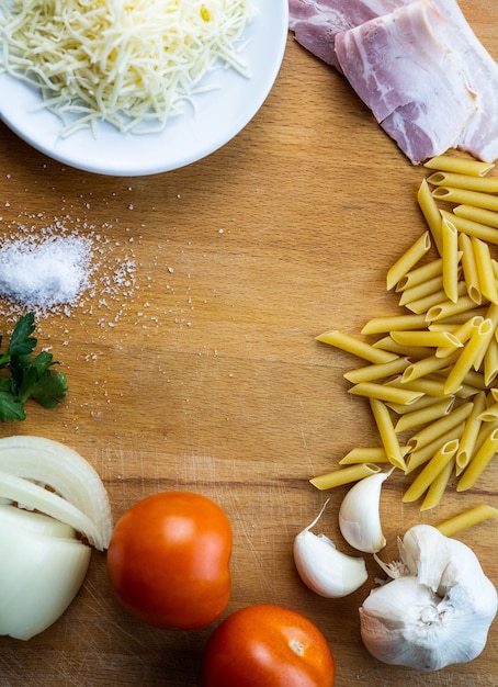 Variety of ingredients for cooking macaroni with sauce