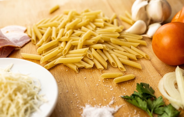 Variety of ingredients for cooking macaroni with sauce