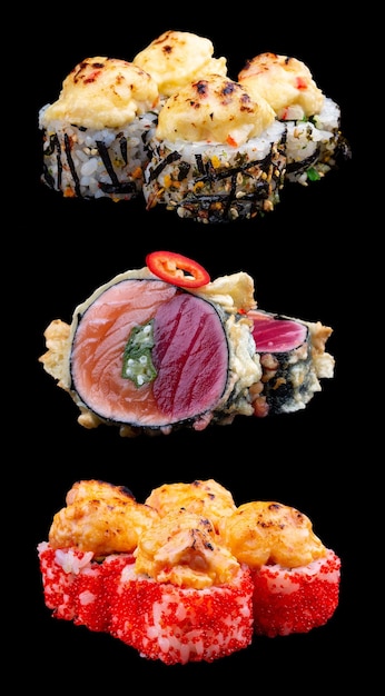 A variety of maki sushi on a glossy black background