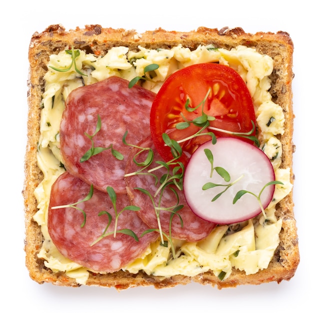 Variety of mini sandwiches with cream cheese, vegetables and salami. Sandwiches with cucumber, radish, tomatoes, salami on a white background, top view. Flat lay.