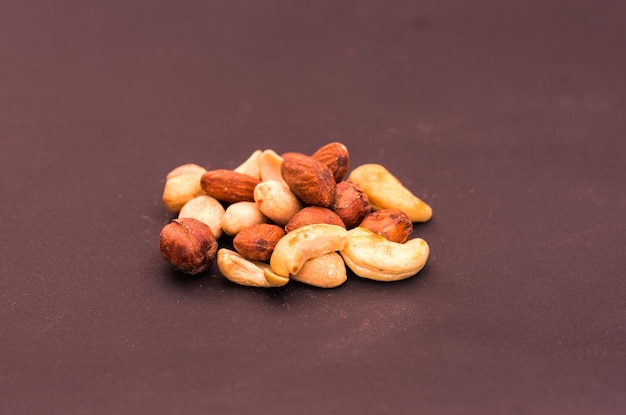 A variety of nuts on a brown background Front view