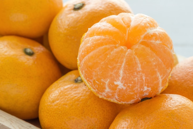 Variety of oranges in box at supermarket. Close-up of citrus.