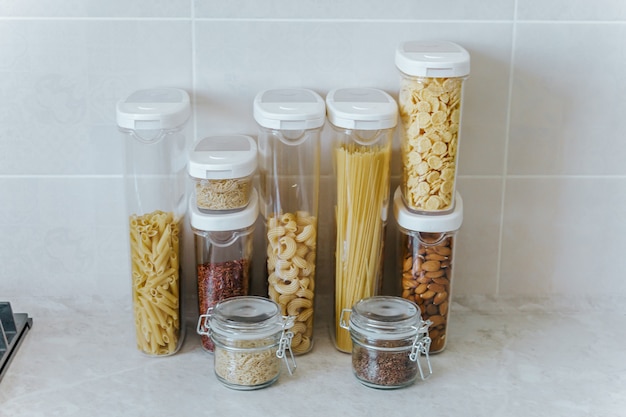 A variety of pasta, rice, cereals, nuts in containers-cans