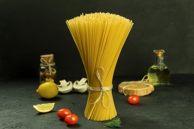 A variety of pasta and spaghetti on a dark background