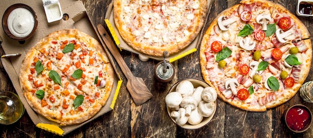 Variety of pizzas with mushrooms and sauce